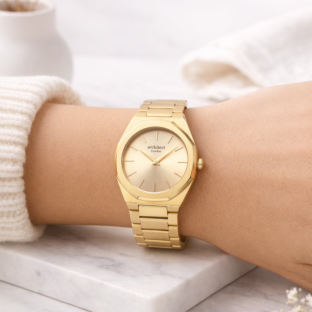 Gold wristwatch on a person's arm with a blurred background