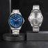 Two silver watches on black stands with a dark background