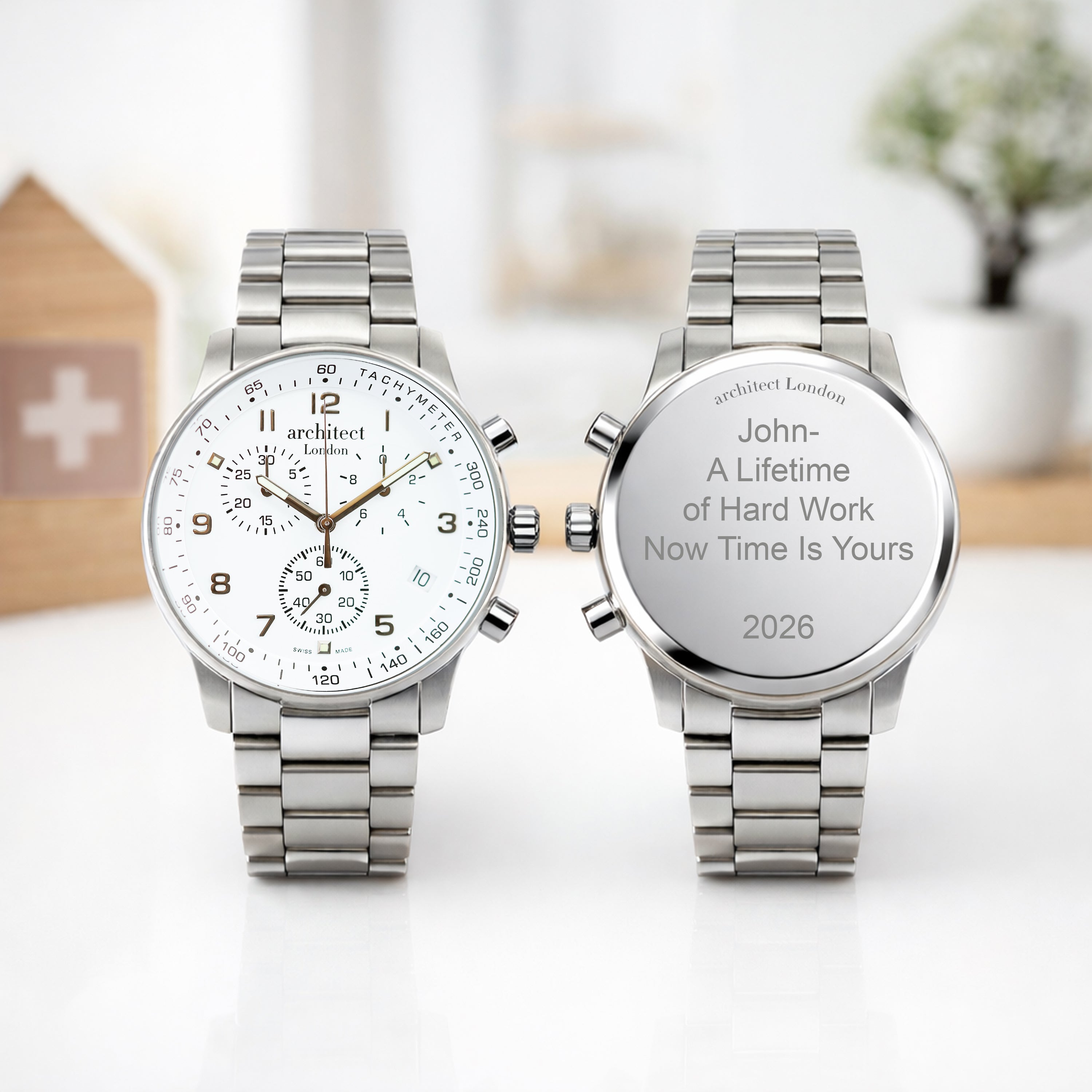 Two silver watches on a white surface with engraved text. Mens swiss made watch personalised on the back