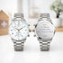 Two silver watches on a white surface with engraved text. Mens swiss made watch personalised on the back