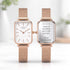 Two rose gold watches with white faces on a blurred background