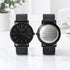 Two mens minimalist wedding watches, one showing engraving at the back
