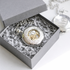 Silver skeleton pocket watch in grey luxury gift box with light grey paper filling