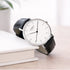 Wedding watch with black leather strap on a white surface