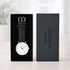 Watch with black strap and white face in a 'architect London' box on a light background