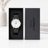Watch with black strap in a 'Architect London' box on a white surface.